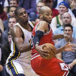 Utah's Derrick Favors works to defend Chicago's Nate Robinson as the Jazz and the Bulls play Friday, Feb. 8, 2013 at Energy Solutions arena.