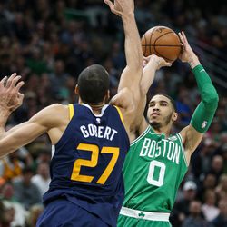 Boston Celtics forward Jayson Tatum (0) shoots over Utah Jazz center Rudy Gobert (27) at Vivint Smart Home Arena in Salt Lake City on Wednesday, March 28, 2018.