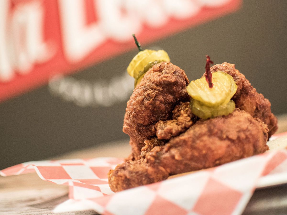 Fried chicken skewered with pickles.