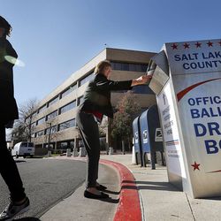 Lucia Heffernan, left, and Judy Petersen place ballots in a drop box at the Salt Lake County Government Center in Salt Lake City on Monday, Nov. 7, 2016.