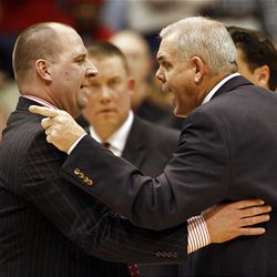 Utah coach Jim Boylen, left, and BYU coach Dave Rose confer after a flagrant foul during their team's matchup Saturday night in Provo. BYU won, 82-69.
