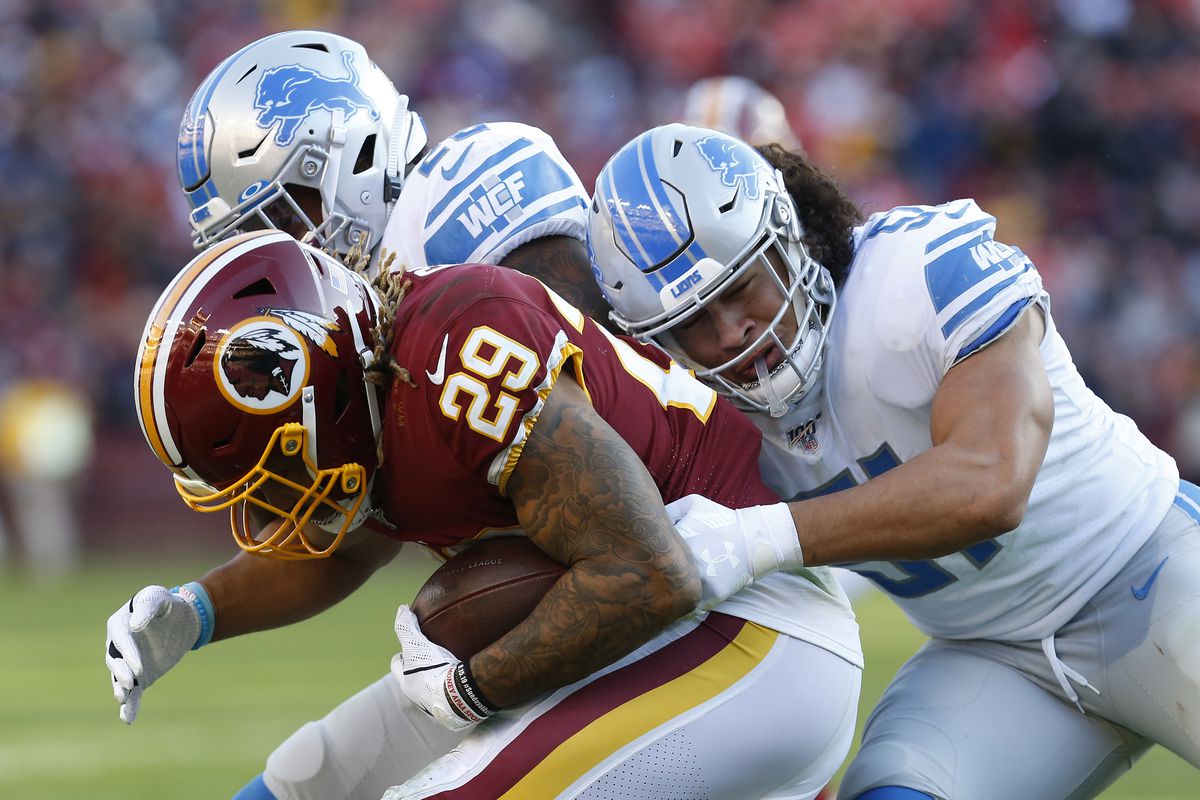Washington running back Derrius Guice carries the ball while being tackled by Detroit Lions linebacker Jahlani Tavai in the third quarter at FedExField.