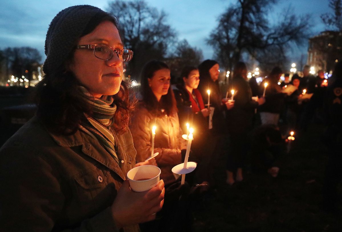 Cassandra Perry and others hold candles during a candlelight vigil in Salt Lake City on Thursday, Dec. 20, 2018, at Pioneer Park to remember the 121 homeless men and women who died during the year.