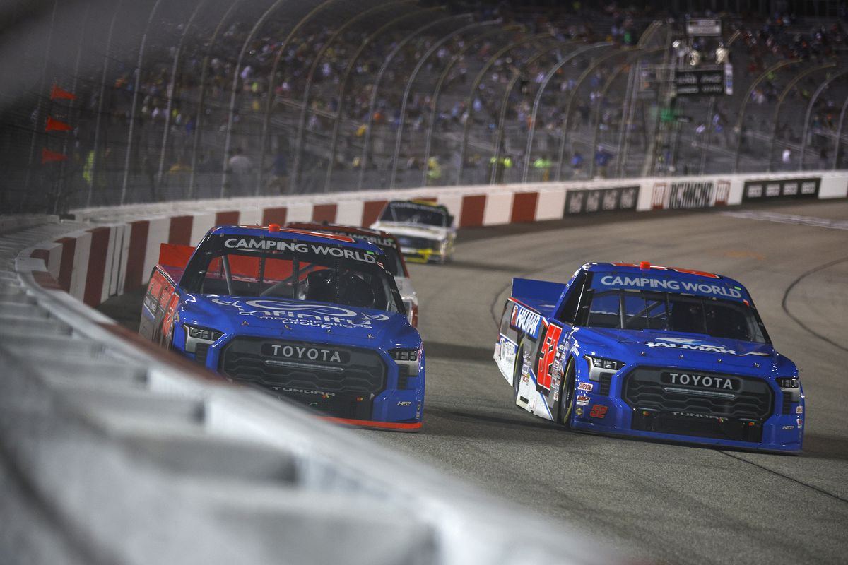 Stewart Friesen, driver of the #52 Halmar International Toyota, and Layne Riggs, driver of the #62 Puryear Tank Lines Toyota, race during the NASCAR Camping World Truck Series Worldwide Express 250 for Carrier Appreciation at Richmond Raceway on August 13, 2022 in Richmond, Virginia.