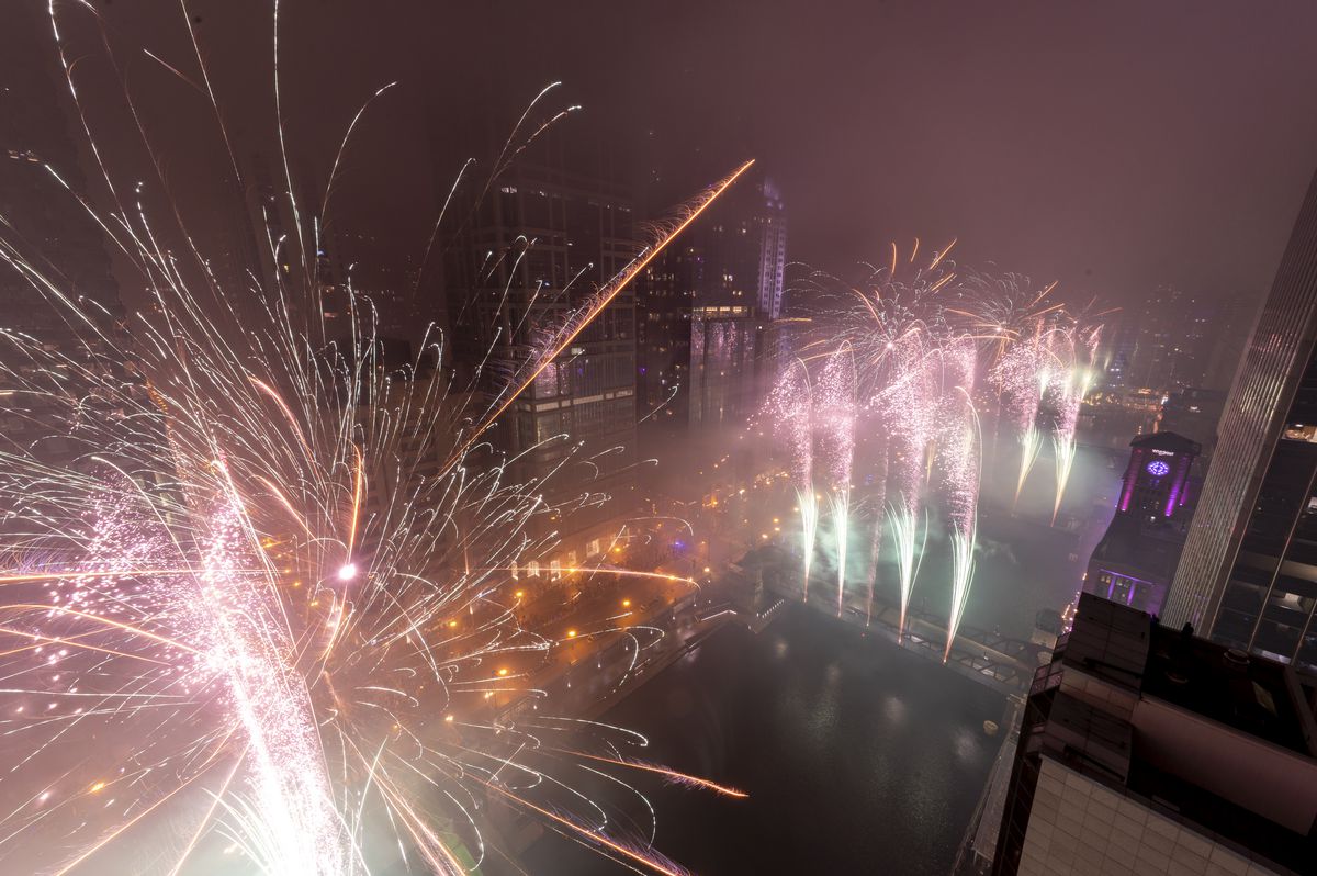 Fireworks explode over the Chicago River as Chicago celebrates the new year, Saturday, Jan. 1, 2022.