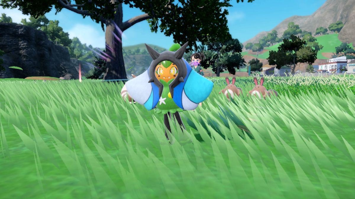 A blue Wellspring Ogerpon in Pokémon Scarlet and Violet in a grassy field