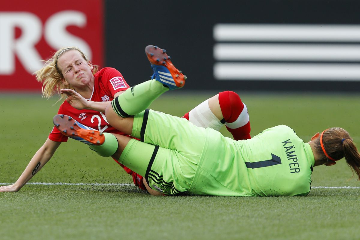 Emma Fletcher of Canada collides with German goalkeeper Meike Kaemper during the FIFA U-20 Women's World Cup Canada 2014 Quarter Final match between Germany and Canada at Commonwealth Stadium on August 16.