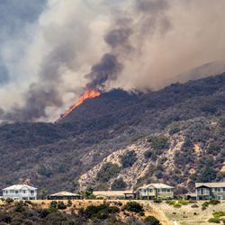The "Holy Fire" burns near homes in Lake Elsinore, Calif., on Wednesday, Aug. 8, 2018. (Mark Rightmire/The Orange County Register via AP)