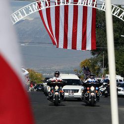 The funeral cortege of U.S. Border Patrol agent Nicholas J. Ivie arrives at the Spanish Fork Cemetery, Thursday, Oct. 11, 2012. 