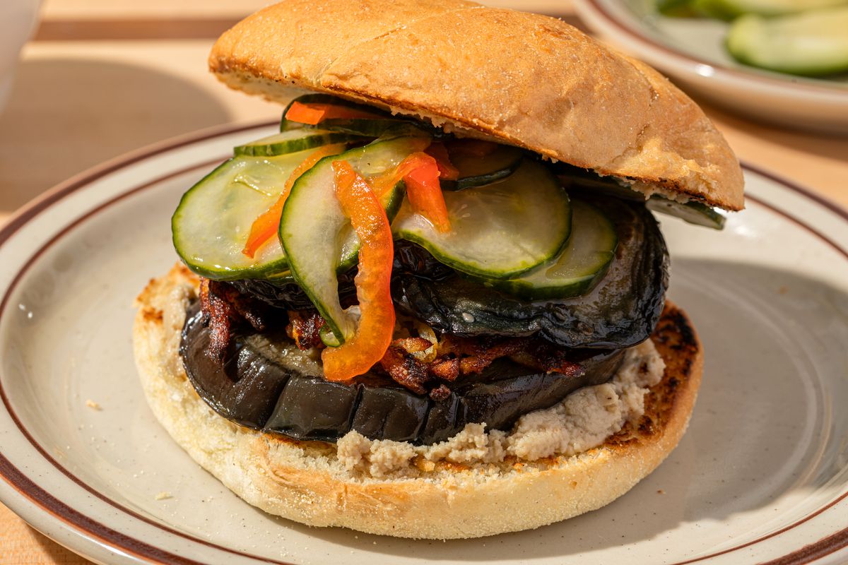 A roasted eggplant sandwich on a toasted bun.