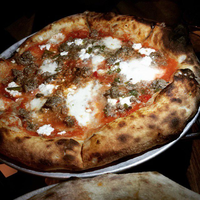 Sausage pizza at Brewer’s Fork. The cornicione, or outer crust, is charred from being cooked in a wood-fired oven. 