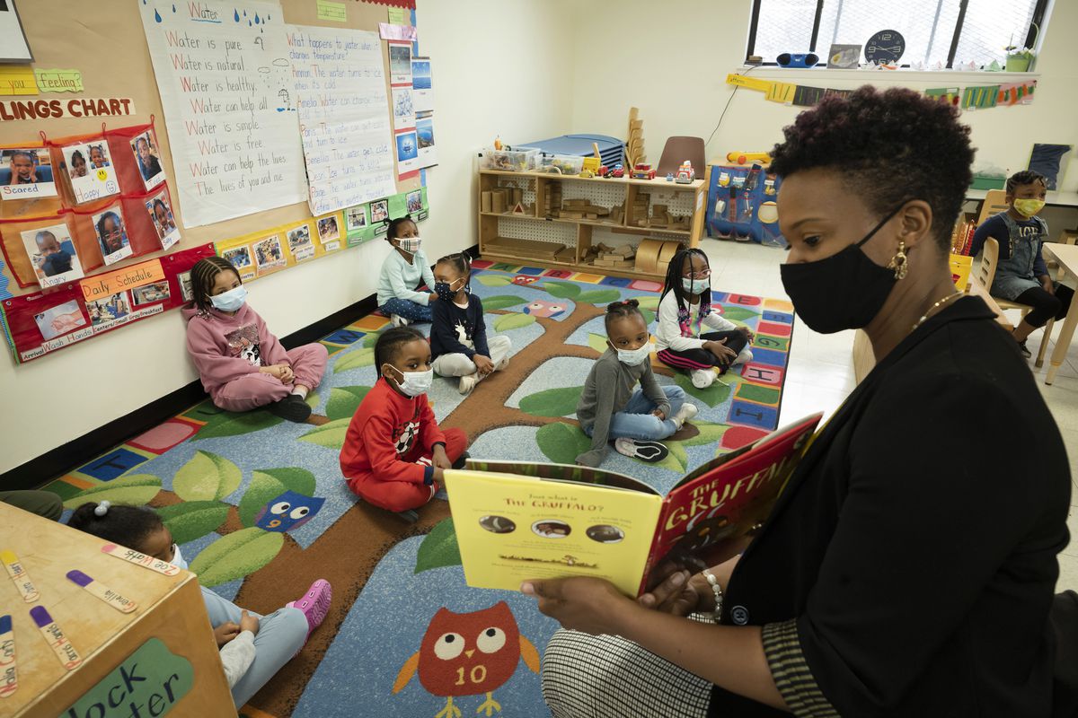 In this March 24, 2021 file photo, Melissa Jean reads “The Gruffalo” to her son’s Pre-K class at Phyl’s Academy, Wednesday, March 24, 2021 in the Brooklyn borough of New York. New York City schools will be all in person this fall with no remote options, Mayor Bill de Blasio announced Monday, May 24, 2021. 