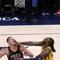 Utah Jazz forward Jae Crowder (99) collides with Phoenix Suns center Alex Len (21) after shooting a basket during a basketball game at the Vivint Smart Home Arena in Salt Lake City on Wednesday, Feb. 14, 2018.