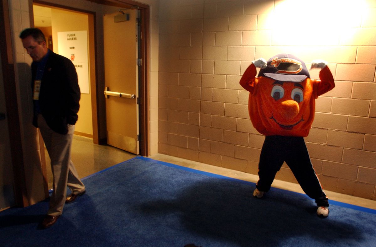 DENVER, COLORADO (03-18-04) Otto the Orange, the mascot of the Syracuse Orangemen warmed up in the halls before the second game at the Pepsi Center Thursday. Syracuse beat BYU 80 to 75 Thursday afternoon. Denver Post Photo by Karl Gehring.