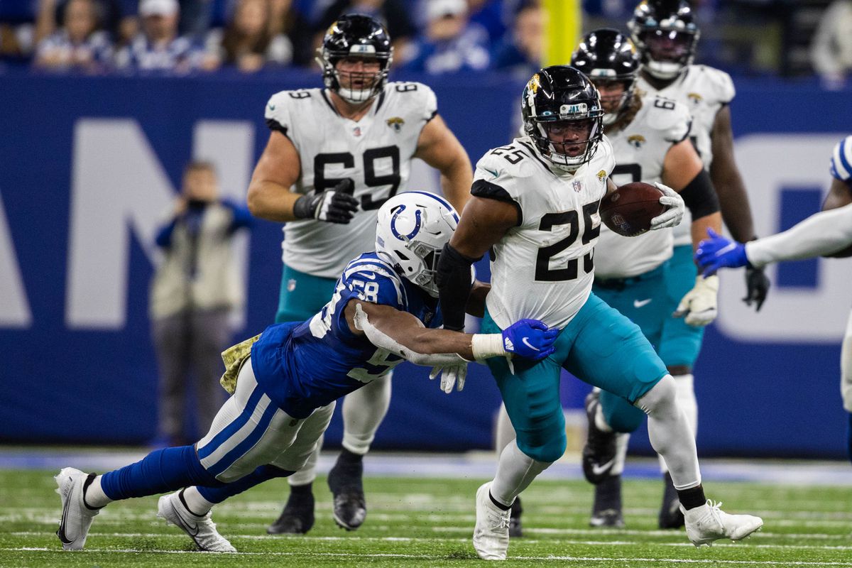 Jacksonville Jaguars running back James Robinson (25) runs the ball while Indianapolis Colts middle linebacker Bobby Okereke (58) defends in the second half at Lucas Oil Stadium.&nbsp;
