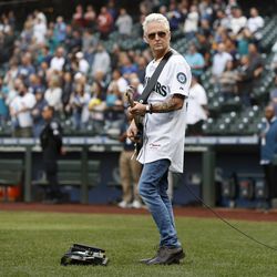 Mike McCready, guitarist of Pearl Jam, performs the national anthem before the game between the Seattle Mariners and the Detroit Tigers