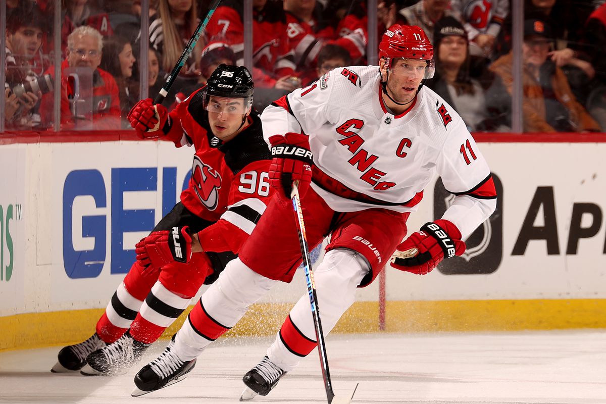 Jordan Staal #11 of the Carolina Hurricanes takes the puck as Timo Meier #96 of the New Jersey Devils defends during the first period at Prudential Center on March 12, 2023 in Newark, New Jersey.