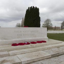 Poppy wreaths are left in front of a marble monument near the Cross of Sacrifice at Tyne Cot cemetery in Zonnebeke, Belgium on Monday, April 15, 2013. With nearly 12,000 graves the cemetery is the largest Commonwealth war cemetery in the world in terms of burials. Renovations are currently underway at the cemetery to accommodate visitors for upcoming centenary events which begin in 2014. 