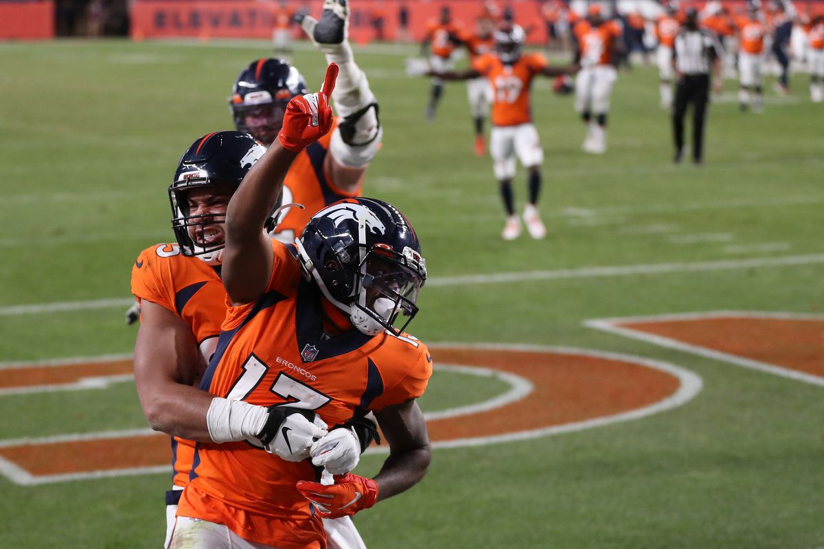 KJ Hamler #13 of the Denver Broncos celebrates with teammate Albert Okwuegbunam #85 after scoring a touchdown against the Los Angeles Chargers at the end of the fourth quarter of the game at Empower Field At Mile High on November 01, 2020 in Denver, Colorado.