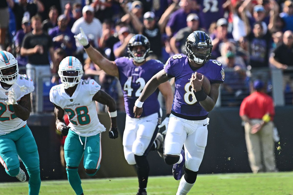 Baltimore Ravens quarterback Lamar Jackson, right, runs for a 79-yard touchdown against the Miami Dolphins on Sept. 18, 2022, at M&amp;amp;T Bank Stadium in Baltimore.