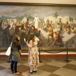 Two young women look at a painting during the afternoon session of General Conference at the LDS Conference Center in Salt Lake City on Saturday, Oct. 1, 2011. 