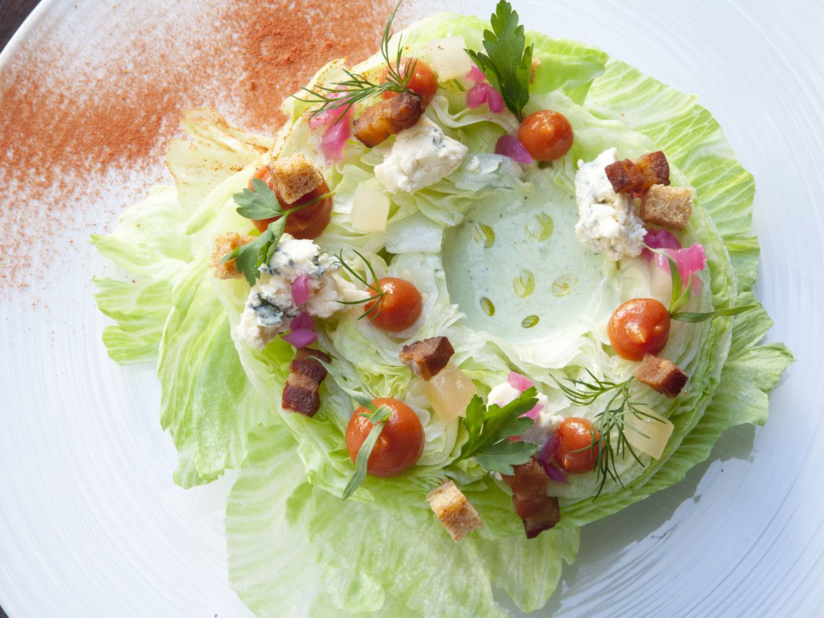 A white plate holds a ring-shaped salad