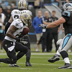 New Orleans Saints' Malcolm Jenkins (27) returns an interception as Carolina Panthers' Ryan Kalil (67) tries to make the tackle in the first half of an NFL football game in Charlotte, N.C., Sunday, Dec. 22, 2013. 