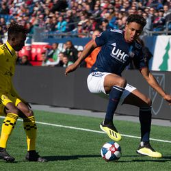 FOXBOROUGH, MA - MARCH 9: New England Revolution forward Juan Agudelo #17 shields the ball from Columbus Crew SC defender Harrison Afful #25 during the first half at Gillette Stadium on March 9, 2019 in Foxborough, Massachusetts. (Photo by J. Alexander Dolan - The Bent Musket)