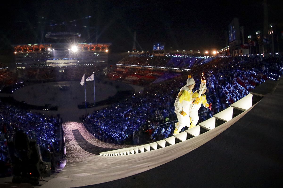 Unified Korea torchbearers, North Korean Jong Su Hyon and South Korean Park Jong-ah hold the Olympic Flame before the lighting of the cauldron.