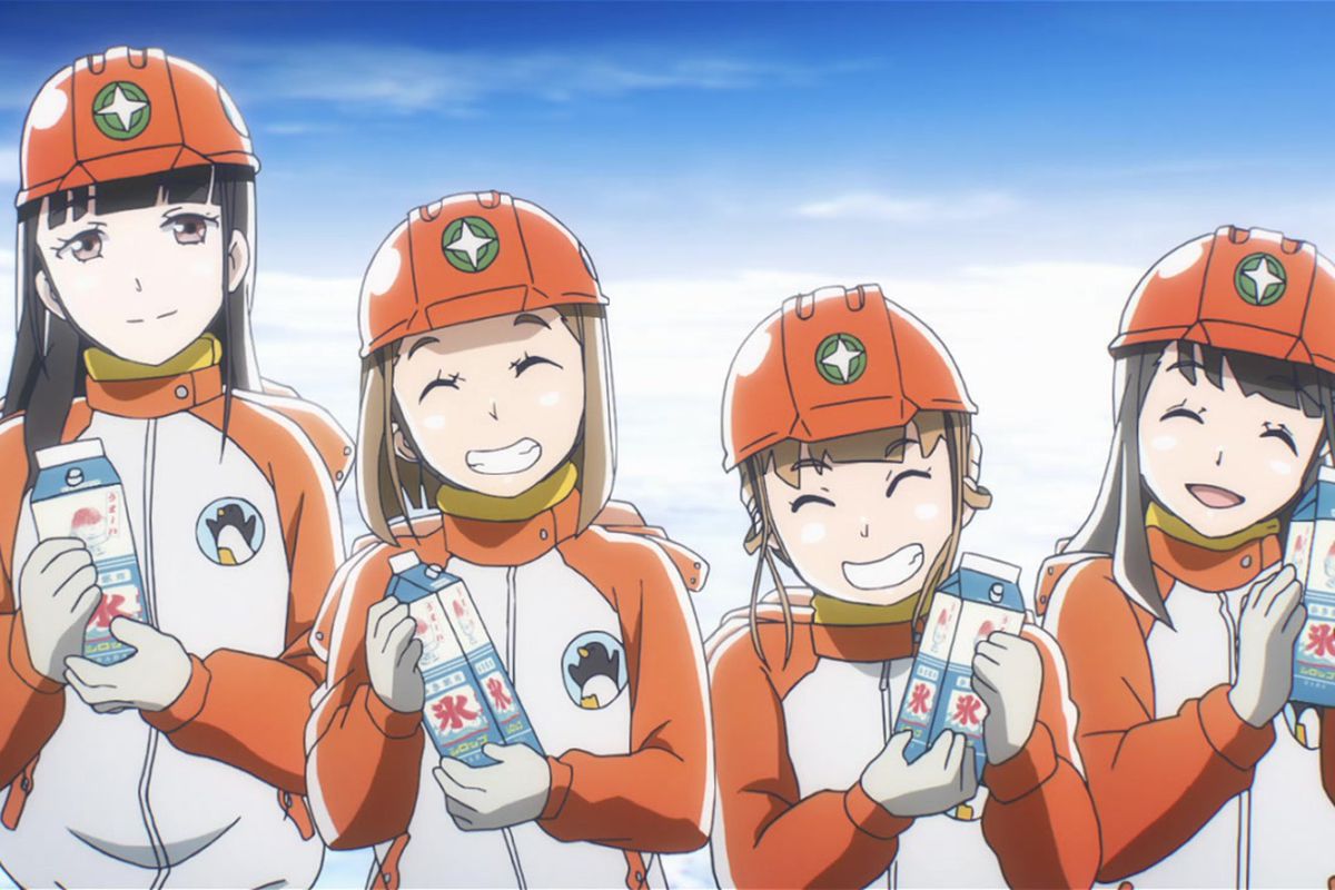 Four anime girls in orange winter gear and matching helmets smile at the viewer.