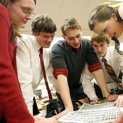 Bear River High School's Bernadette Hess, left, Dillon Pierson, Tyler Christensen, Tim Bitner and Ashley Funk peruse scholar photos as they wait for their turns with the judges.  
