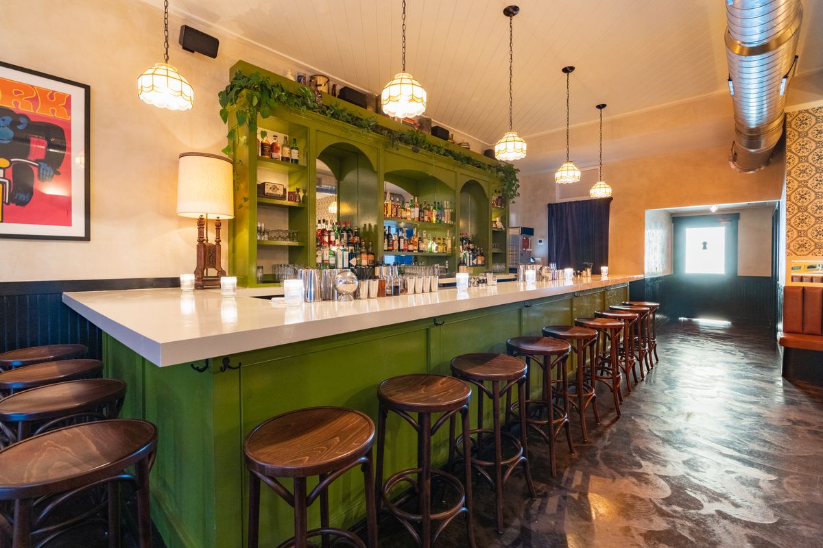 Green bar with wooden stools. 