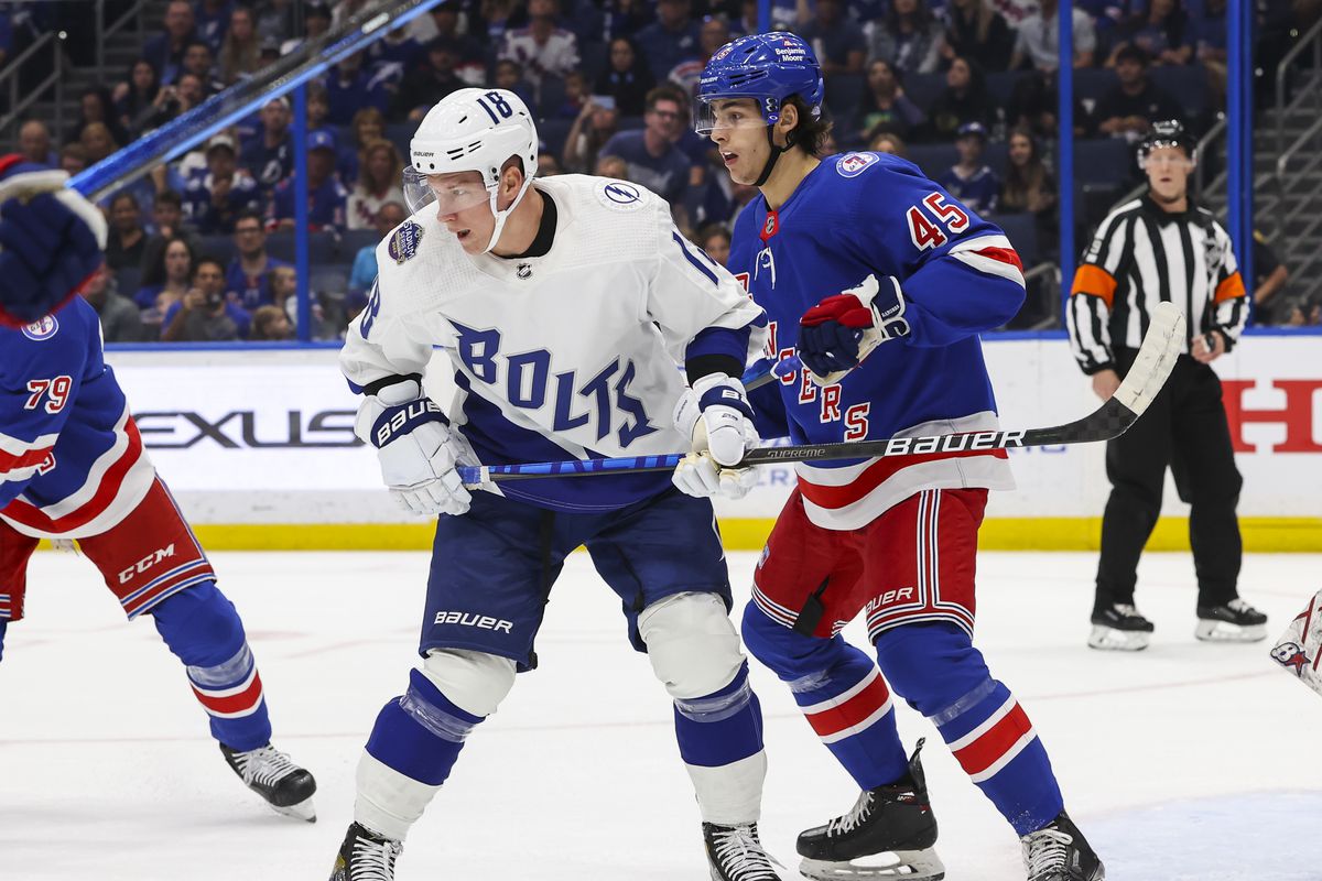 Ondrej Palat #18 of the Tampa Bay Lightning skates against Braden Schneider #45 of the New York Rangers during the first period at Amalie Arena on March 19, 2022 in Tampa, Florida.
