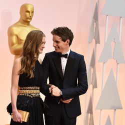 Hannah Bagshawe, left, and Eddie Redmayne arrive at the Oscars on Sunday, Feb. 22, 2015, at the Dolby Theatre in Los Angeles. 