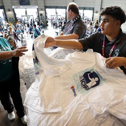 SEATTLE, WASHINGTON - AUGUST 27: Ichiro Suzuki shirts are handed to fans prior to his induction into the Mariners Hall of Fame prior to the game between the Cleveland Guardians and the Seattle Mariners at T-Mobile Park on August 27, 2022 in Seattle, Washington.