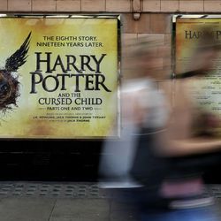 Pedestrians pass a poster advertising the new Harry Potter play, at the Palace Theatre in London on Thursday, July 28, 2016. Nine years after J.K. Rowling's final novel about the boy wizard, Harry has returned, on the stage and the page — and he's still producing commercial alchemy. "Harry Potter and the Cursed Child," a two-part stage drama that picks up 19 years after the novels ended, has its gala opening Saturday at London's Palace Theatre, and is all-but sold out through December 2017.