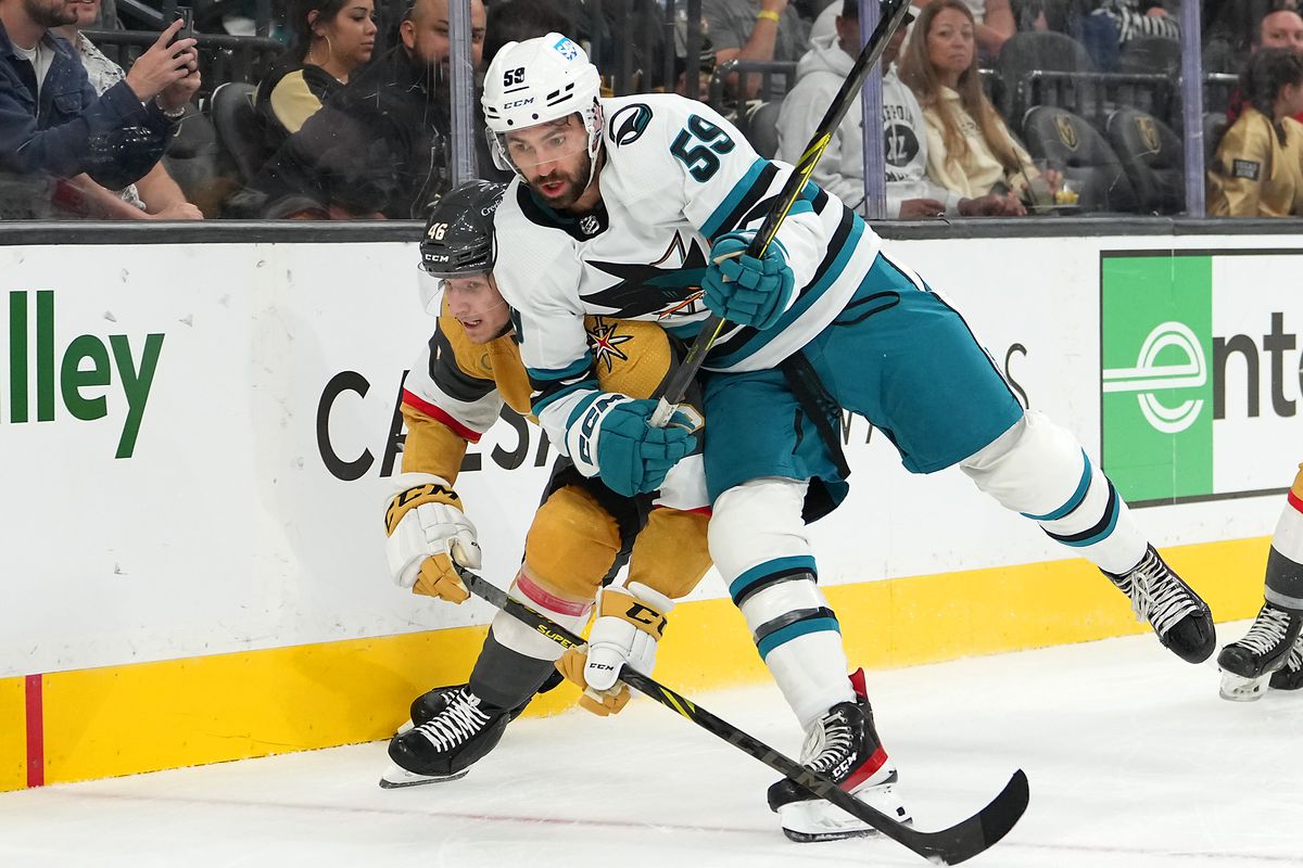Sep 30, 2022; Las Vegas, Nevada, USA; San Jose Sharks defenseman Nick Cicek (59) leans into Vegas Golden Knights right wing Jonas Rondbjerg (46) during the second period of a preseason game at T-Mobile Arena.