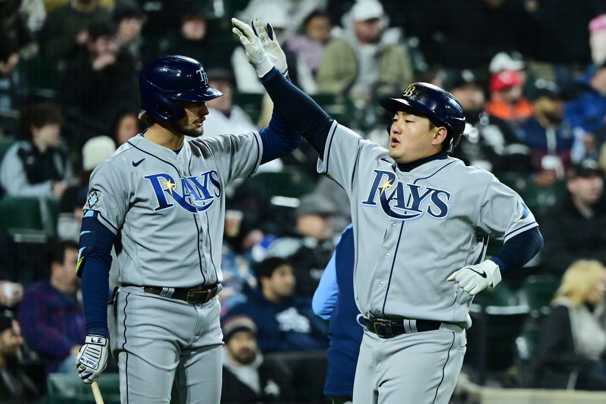 Ji-Man Choi #26 of the Tampa Bay Rays celebrates after scoring in the sixth inning against the Chicago White Sox at Guaranteed Rate Field on April 15, 2022 in Chicago, Illinois. All players are wearing the number 42 in honor of Jackie Robinson Day.