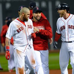 Boston Red Sox shortstop Stephen Drew (right) reacts after left fielder Jonny Gomes (left) scored the winning run during the ninth inning in Game 2 of the ALCS at Fenway Park.