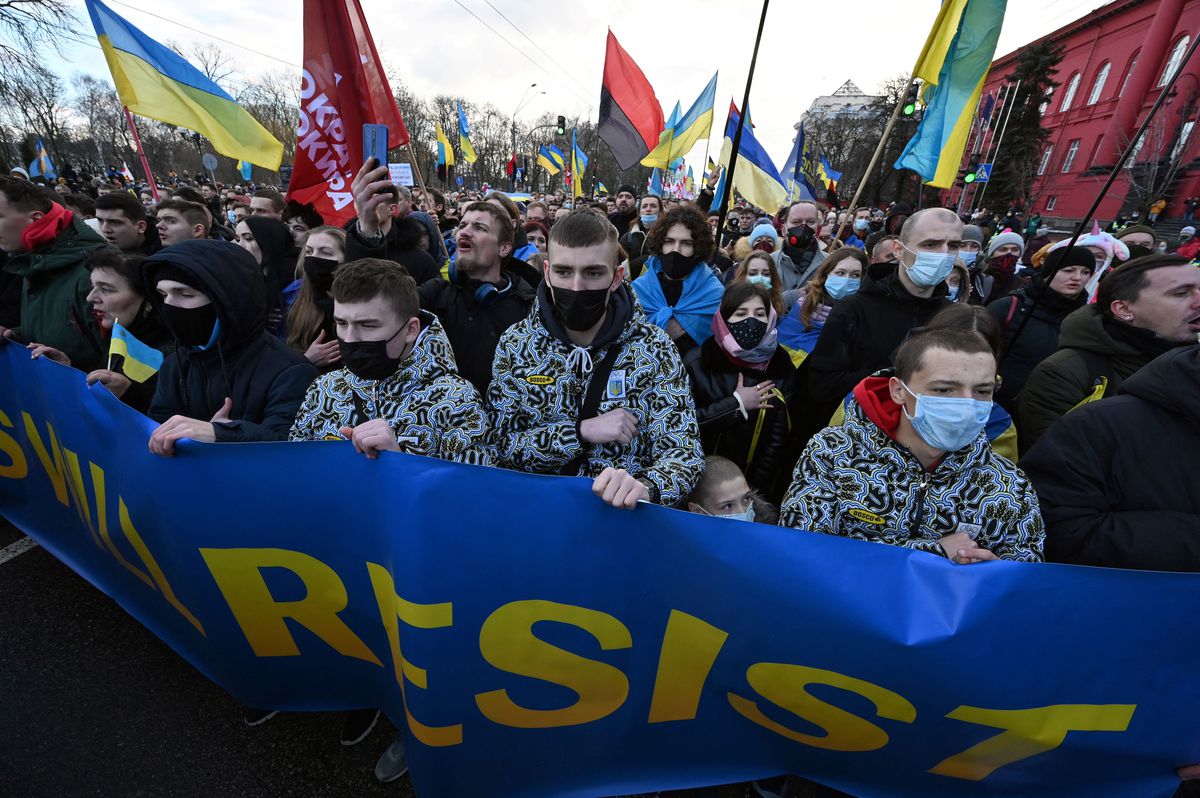 Demonstrators shout slogans as they march behind a banner which reads “Ukrainians will resist” in the colors of the Ukrainian national flag during a rally in Kyiv, Ukraine, on February 12, 2022.