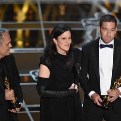 Dirk Wilutzky, from left, Laura Poitras and Glenn Greenwald accept the award for best documentary feature for “Citizenfour” at the Oscars on Sunday, Feb. 22, 2015, at the Dolby Theatre in Los Angeles. 