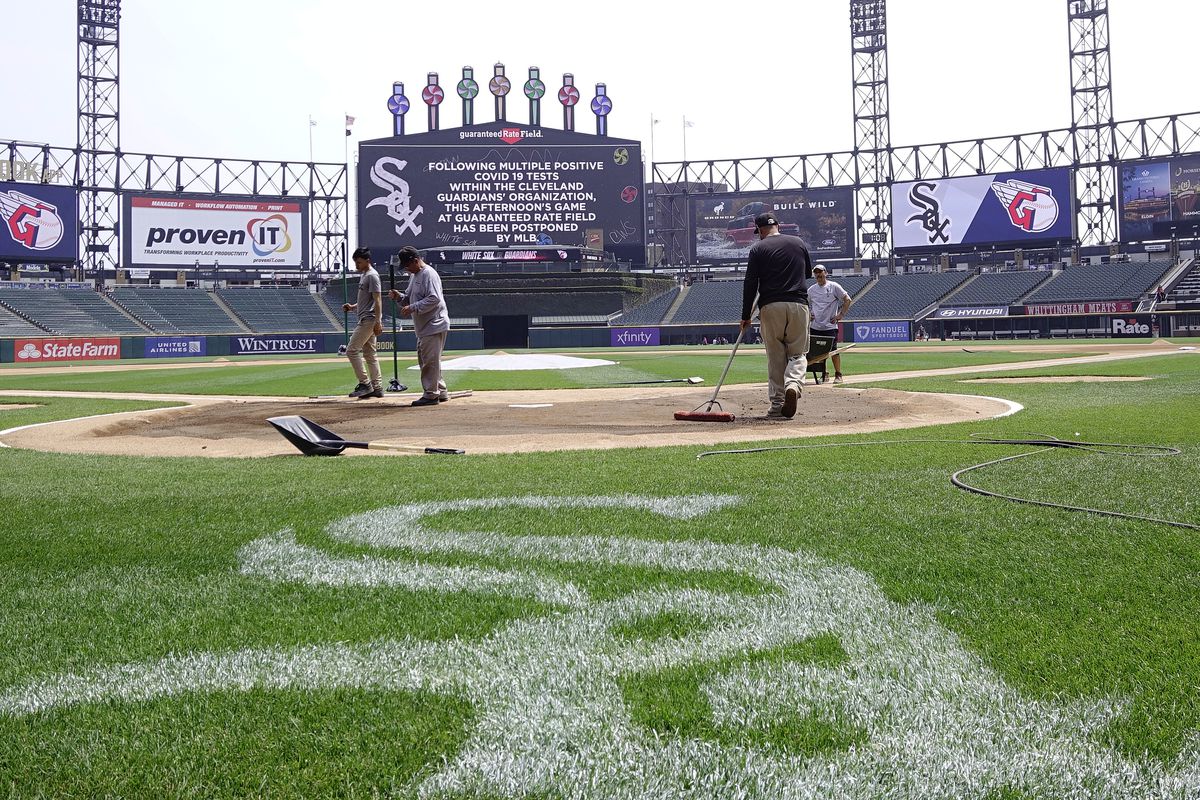 Grounds crew works on the field that is home to the Chicago White Sox.