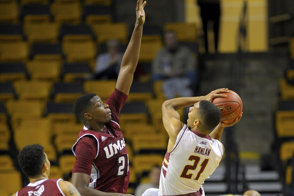 Olivier Hanlan (21) attempts to shoot over Cady Lalanne (25)