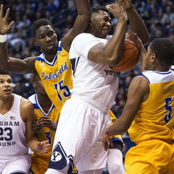 Cal State Bakersfield center Fallou Ndoye (15) commits a foul against Brigham Young forward Jamal Aytes (40) during an NCAA college basketball game in Provo on Thursday, Dec. 22, 2016. Brigham Young held off Cal State Bakersfield for the win with a final score of 81-71.