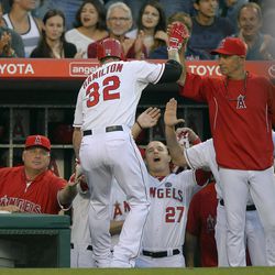 Los Angeles Angels right fielder Josh Hamilton (32) is greeted by manager Mike Sciocia, left, and teammates after hitting a two-run home run against the Seattle Mariners in the second inning of a baseball game,  Monday, June 17, 2013 in Anaheim, Calif.  