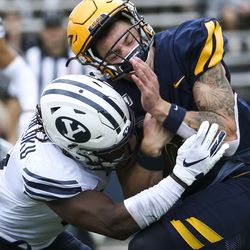 Toledo Rockets quarterback Mitchell Guadagni (6) collides with Brigham Young Cougars defensive back Dayan Ghanwoloku (5) after picking up the first down for Toledo during the second half of an NCAA football game at The Glass Bowl in Toledo, Ohio on Saturday, Sept. 28, 2019. The Cougars fell 28-21 to the Rockets.