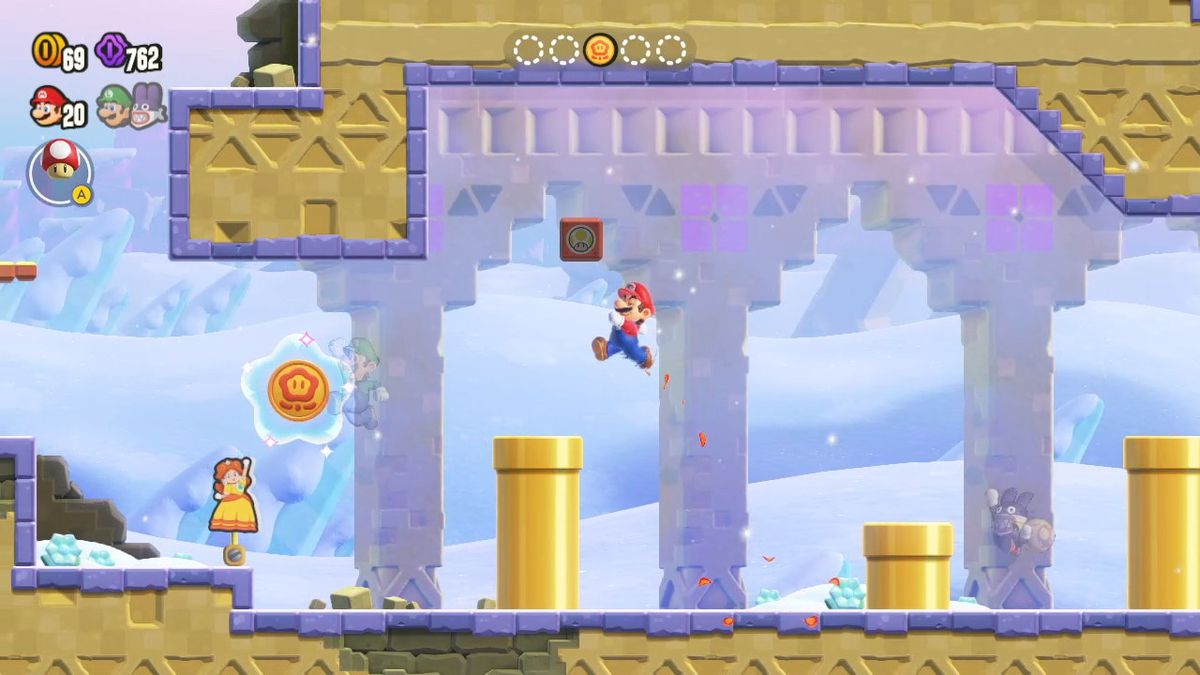 View of a Super Mario Bros. Wonder stage, with the player as Mario and see-through avatars of other players as Yoshi and Nabbit, plus a Daisy standee