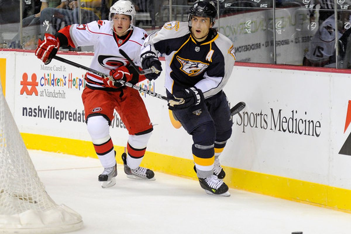 NASHVILLE TN - SEPTEMBER 23:  Marcel Goc #9 of the Nashville Predators and Drayson Bowman #21 of the Carolina Hurricanes chase the puck at Bridgestone Arena on September 23 2010 in Nashville Tennessee.  (Photo by Frederick Breedon/Getty Images)