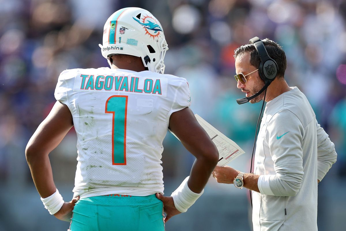 Miami Dolphins head coach Mike McDaniel talks to Tua Tagovailoa #1 during a game against the Baltimore Ravens at M&amp;T Bank Stadium on September 18, 2022 in Baltimore, Maryland.