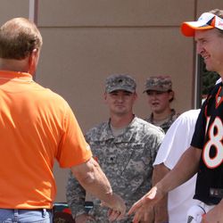 Broncos quarterback Peyton Manning shakes hands with former Broncos LB Randy Gradishar before meeting with members of the US Army